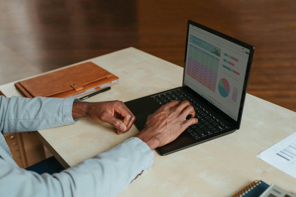 Small business professional working calmly on laptop at desk, photo by Windows
