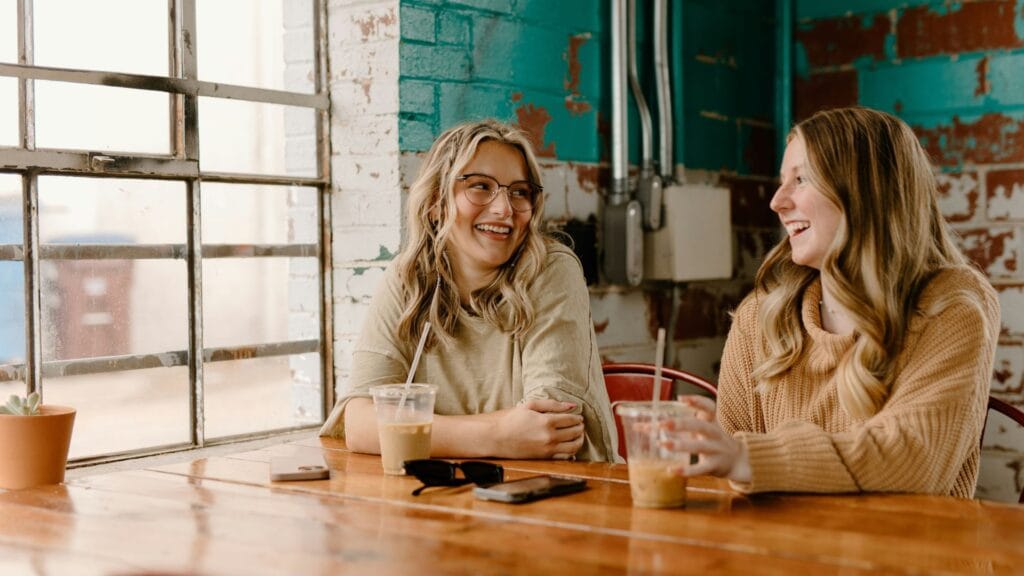 Two friends chatting in a coffee shop. Photo by Brooke Cagle.