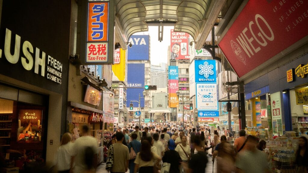 Crowded shop signage in a busy market place. Photo by Buddy An.