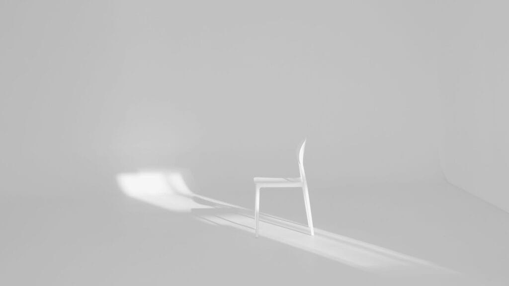 A single chair in a clean room to symbolise simple website design. Photo by Ellen Qui. 
