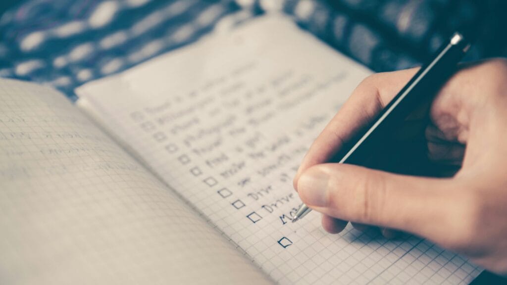 An image of a checklist being handwritten and ticked off. Photo by Glenn Carstens Peters. 