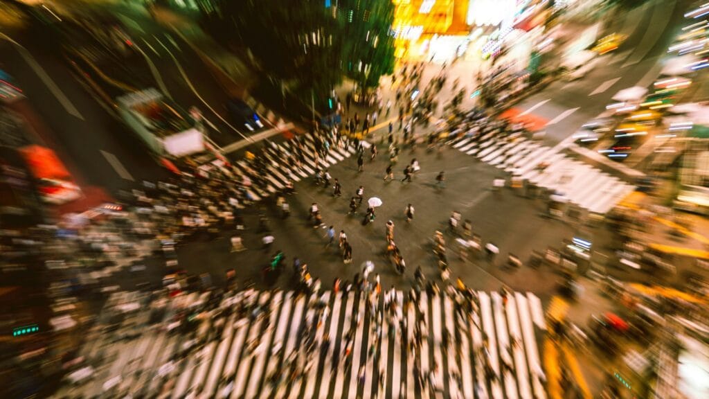Blurred crowd crossing representing confusion and overwhelm on unclear websites photo by Nathan Tony Wang. 