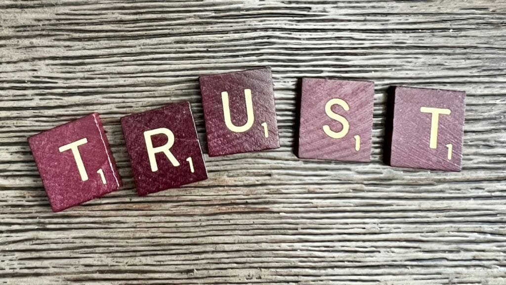 Trust written in scrabble tiles. Representing building trust on websites. Photo by Ronda Dorsey.