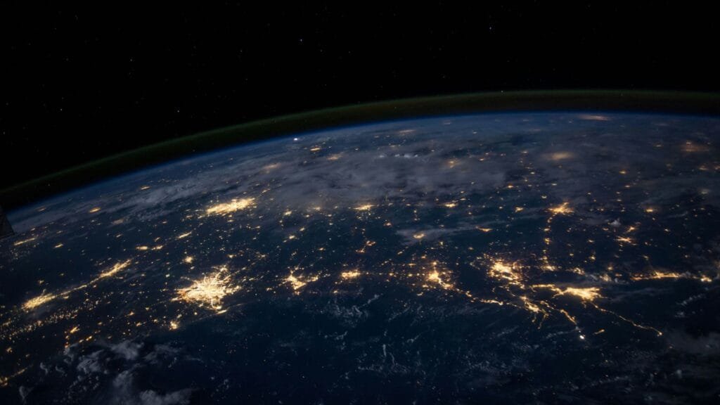 View of Earth at night from space representing global digital connectivity and the evolving role of business websites. Photo by NASA.